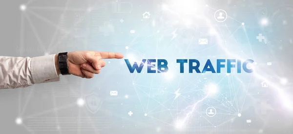 Hand pointing at WEB TRAFFIC inscription, modern technology concept