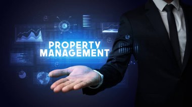 Mülkiyet Yönetimi yazıtlarını tutan İşadamı 'nın eli, iş başarısı kavramı