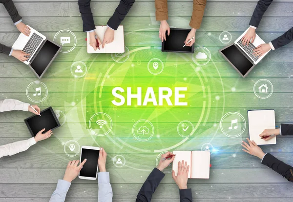 Group of people having a meeting with SHARE insciption, social networking concept