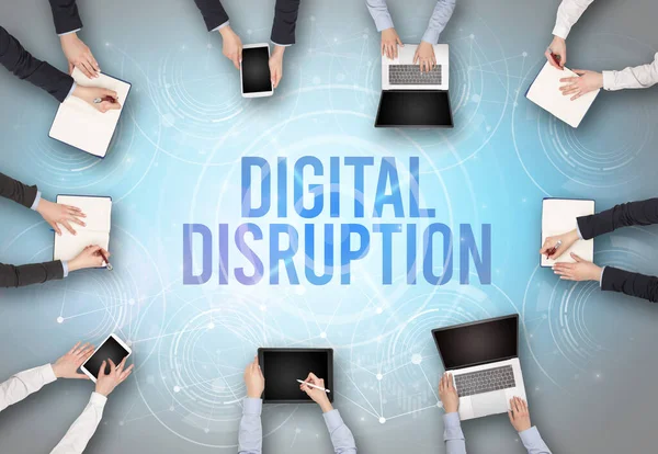 Group of people in front of a laptop with DIGITAL DISRUPTION insciption, web security concept