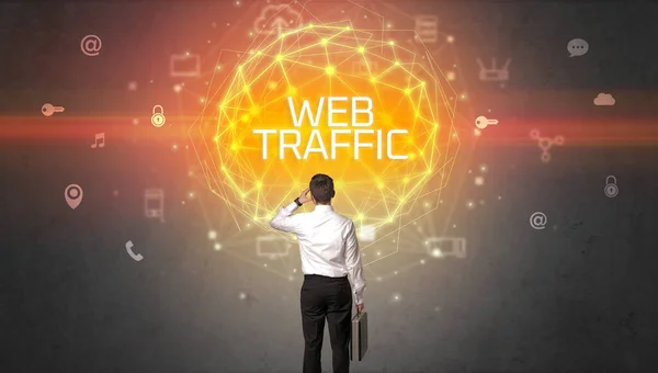 Rear view of a businessman with WEB TRAFFIC inscription, online security concept