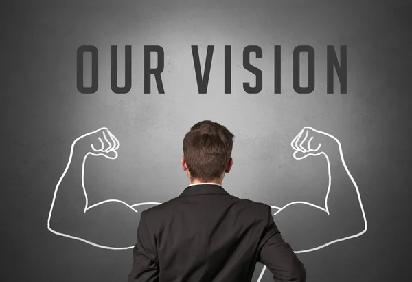 Rear view of a businessman with OUR VISION inscription, powerfull business concept