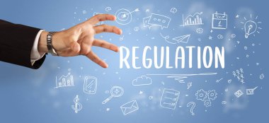 Kesilmiş ellerin yakın çekimi REGULATION yazıtlarına işaret ediyor, modern iş çözümleri kavramı