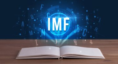 Açık bir kitaptan çıkan IMF yazımı, dijital teknoloji konsepti