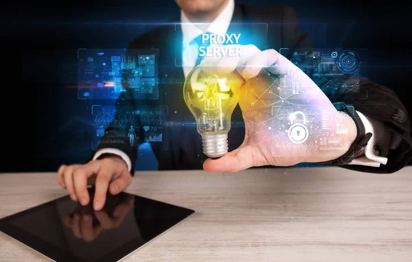 Businessman Holding Lightbulb Proxy Server Inscription Online Security Idea Concept — Stockfoto