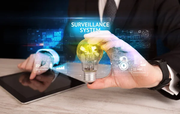 Businessman Holding Lightbulb Surveillance System Inscription Online Security Idea Concept — Stock Photo, Image