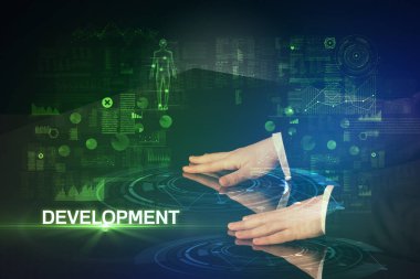 İş adamı DEVELOPMENT yazıtları ve modern teknoloji konseptiyle büyük ekrana dokunuyor