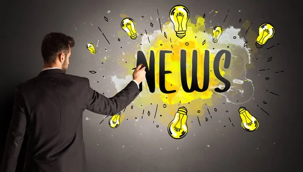 businessman drawing colorful light bulb with NEWS abbreviation, new technology idea concept
