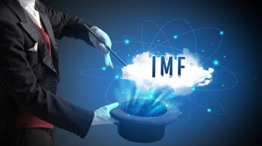 Sihirbaz IMF kısaltması olan modern teknoloji konseptiyle sihirbazlık numarası gösteriyor