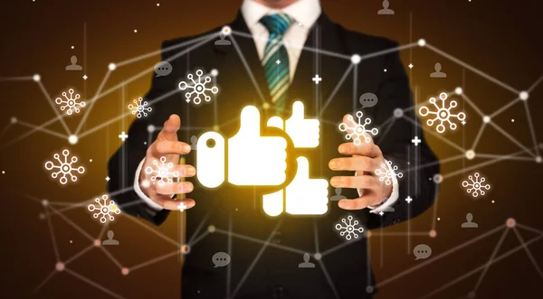 Hand holdig likes icon around his hands, Social networking concept
