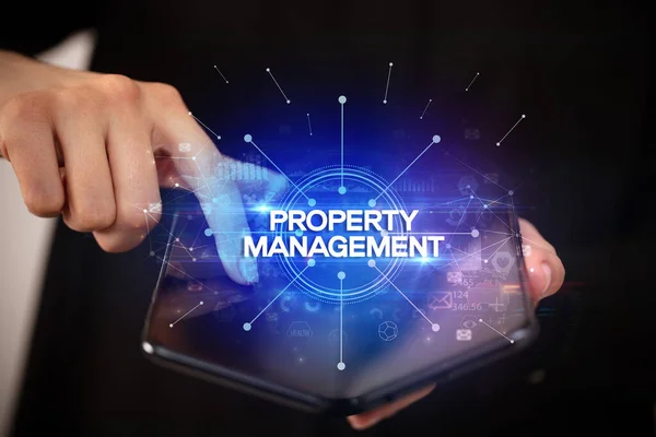 Zakenman Het Bezit Van Een Opvouwbare Smartphone Met Property Management — Stockfoto