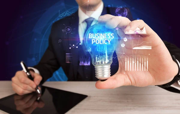 Uomo Affari Possesso Lampadina Con Iscrizione Business Policy Business Idea — Foto Stock