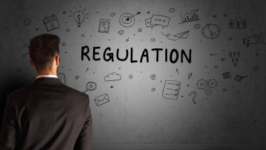 İş adamı, REGULATION yazıtları ve iş stratejisi konseptiyle yaratıcı bir fikir çizimi yapıyor.