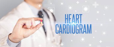 Kalp Kardiyogramı yazıtlı, tıbbi konseptli ilaç veren bir doktorun yakın çekimi.