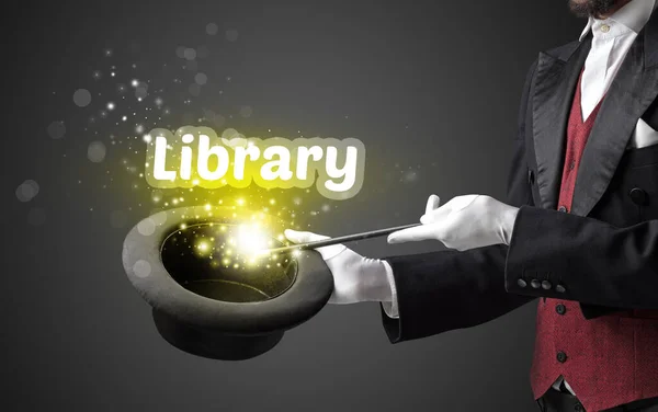Magician is showing magic trick with Library inscription, educational concept
