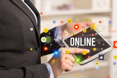 Sosyal medya simgeleri ve ONLINE yazıtlarıyla multimedya oynayan iş adamını kapat