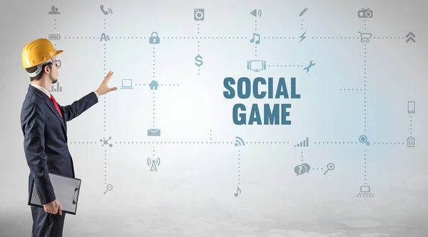 Engineer working on a new social media platform with SOCIAL GAME inscription concept