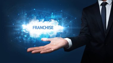 FRANCHISE yazıtlarını tutan İşadamı 'nın eli, başarılı iş kavramı