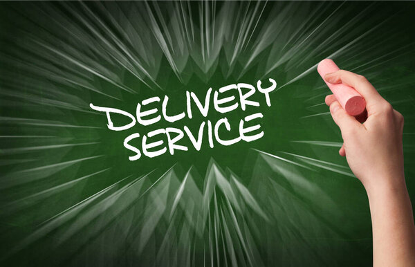 Hand drawing DELIVERY SERVICE inscription with white chalk on blackboard, online shopping concept