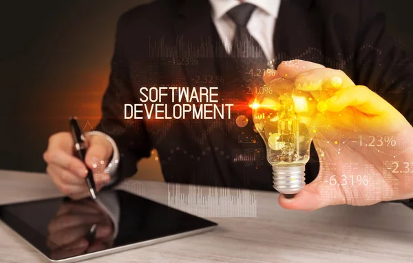 Podnikatel Držící Žárovku Nápisem Software Development Business Technology Koncept — Stock fotografie