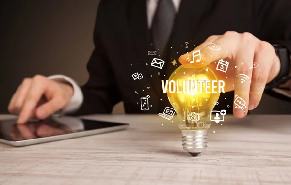 Businessman Holding Light Bulb Volunteer Inscription Social Media Concept — Stock Photo, Image
