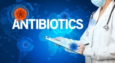 Doktor, AnTIBIOTICS yazıtları ve viroloji konseptiyle tıbbi kayıtları dolduruyor.