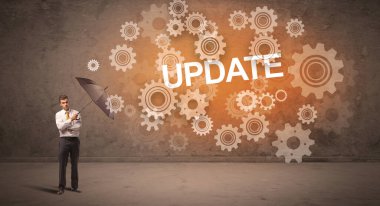 UPDATE yazıtları ve teknoloji kavramından şemsiyeyle savunma yapan iş adamı