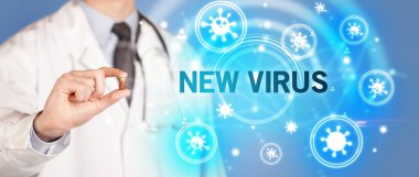 Yeni VIRUS yazıtlı, koronavirüs konseptli ilaç veren doktor.