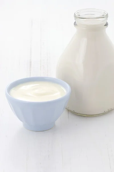 Milk bottle and plain yogurt — Stock Photo, Image