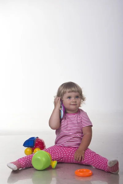 Baby girl playing with toys — Stock Photo, Image