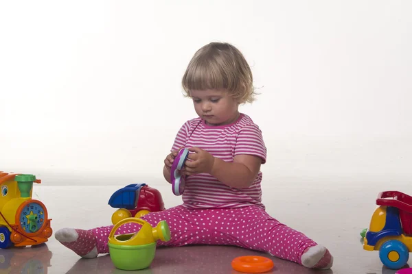 Baby girl playing with toys — Stock Photo, Image