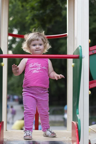 Adorable little girl having fun on a playground — Stock Photo, Image