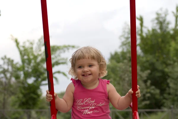 Little girl having fun on swing — Stock Photo, Image