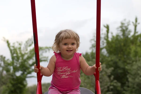 Little girl having fun on swing — Stock Photo, Image