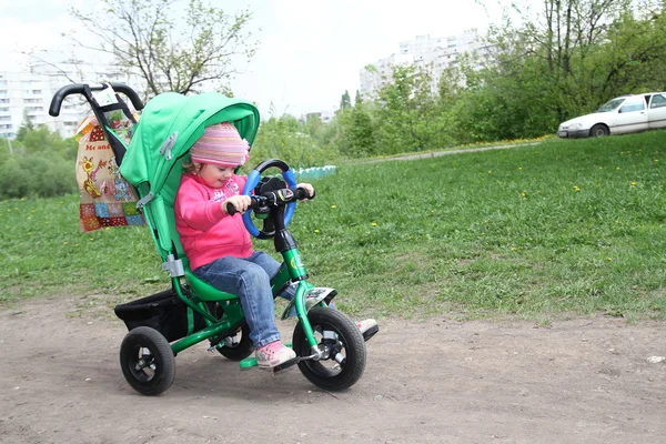 Adorable little girl rides a bike — Stock Photo, Image