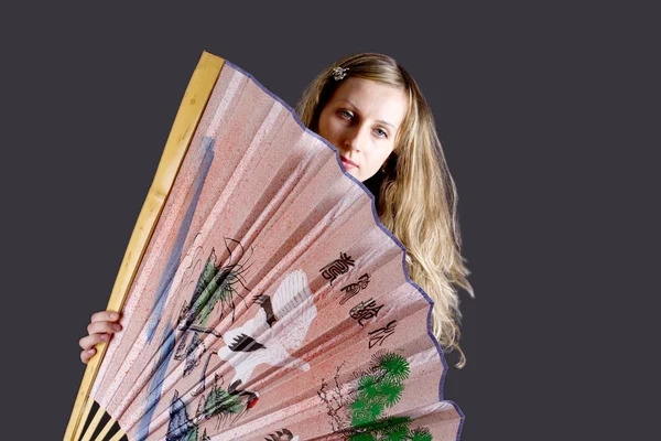 Beautiful woman with big chinese fan — Stock Photo, Image