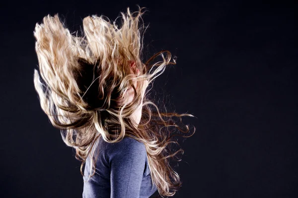 Girl with long hair on black background — Stock Photo, Image