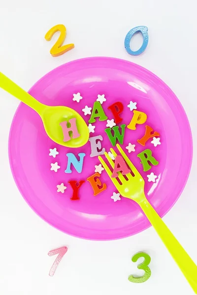 Colorful character Happy New Year greetings in plastic dishes — Stock Photo, Image