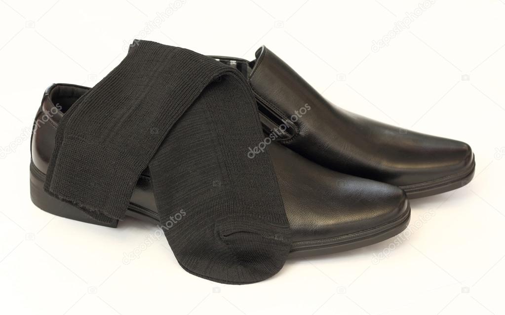 Man's black shoes and socks isolated on white background