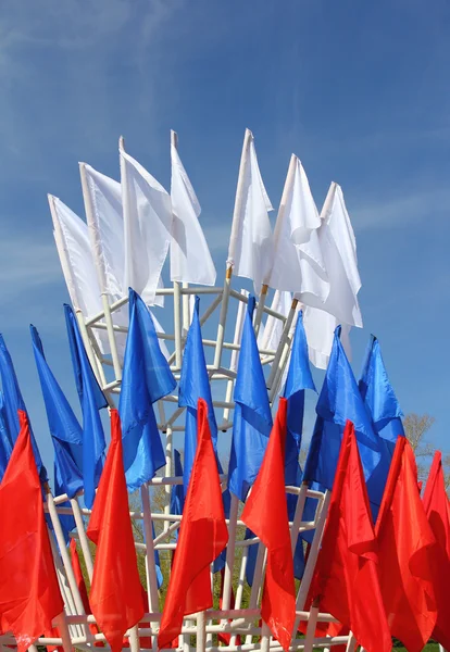 Colored flags on a blue sky background — Stock Photo, Image