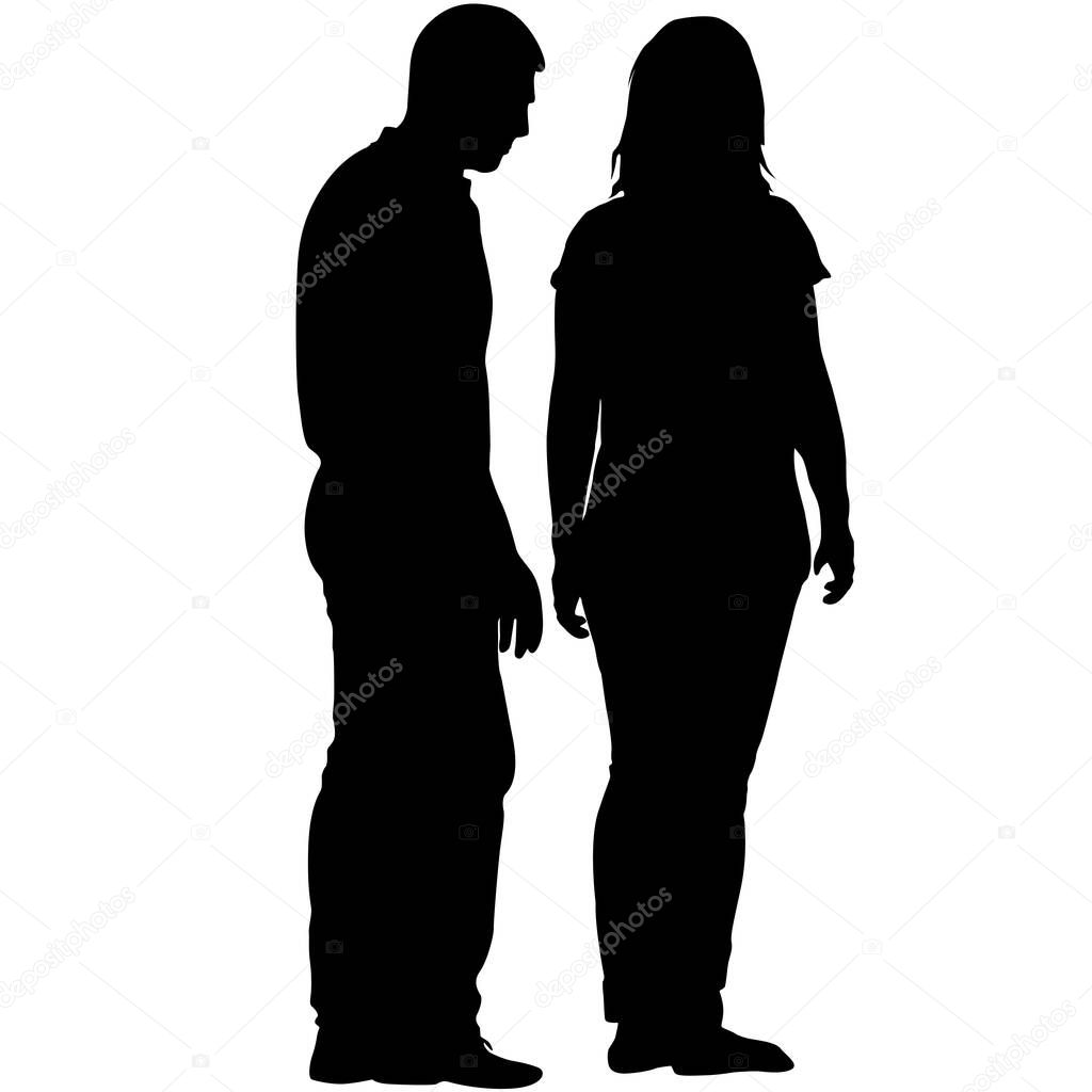 Silhouette man and woman stand side by side and talk.