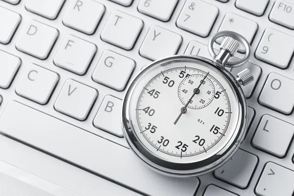 Stopwatch on a laptop keyboard — Stock Photo, Image