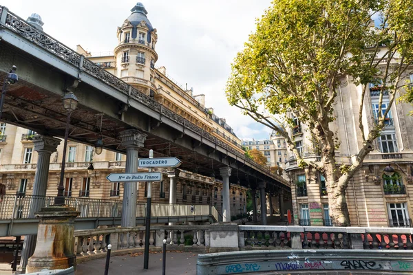 Metro runs high between buildings in Paris