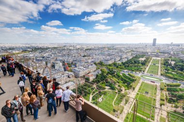 Tourists are on the observation deck of the Eiffel Tower in Pari clipart