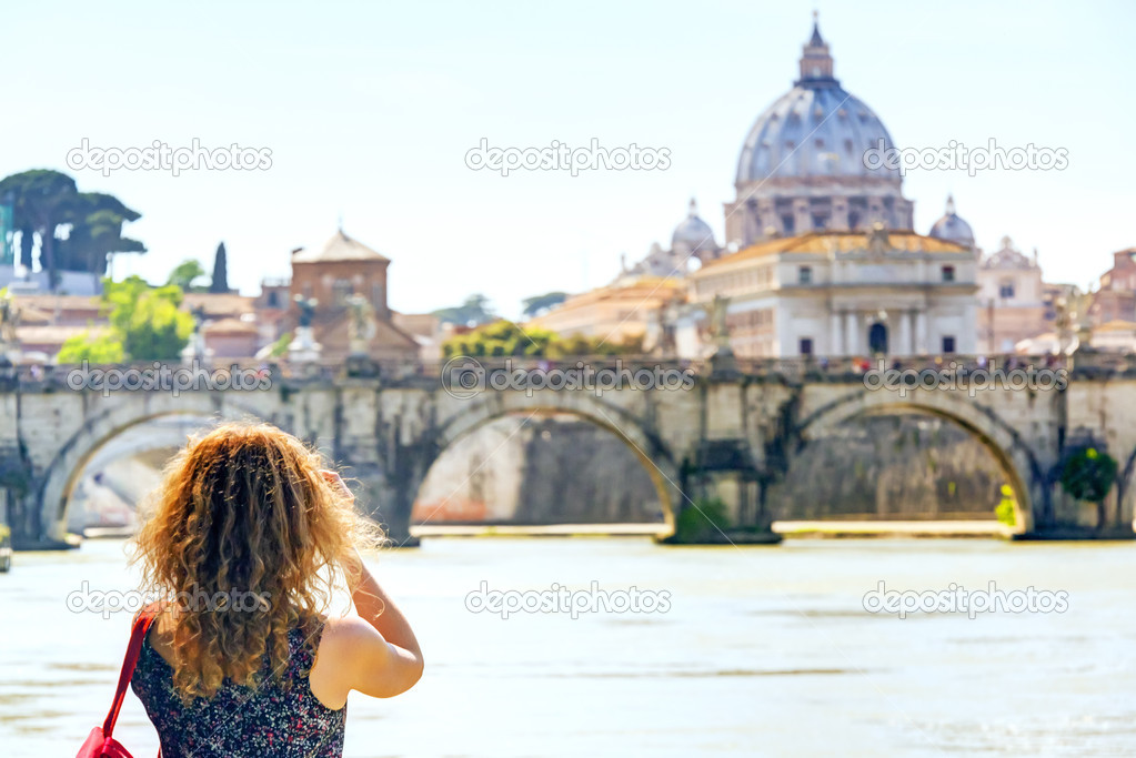 Young woman photographs the Cathedral of St. Peter in Rome