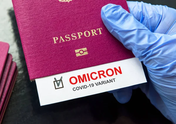 Omicron COVID-19 variant and travel concept, test positive result note in passport. Corona virus diagnostics in airport and border control due to new coronavirus strain, restrictions and lockdown.