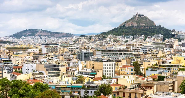 Panorama of Athens, view of Lycabettus mount from Acropolis foot, Greece. Skyline of Athens city center. Cityscape of historical town of Athens with old and modern Greek houses. Travel concept.