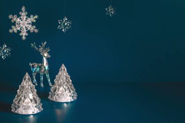 Koyu mavi arka planda Noel süslemeleri olan kış sahnesi