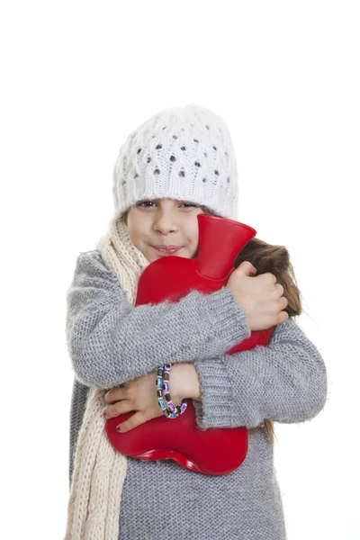 Criança de inverno com garrafa de água quente Fotos De Bancos De Imagens
