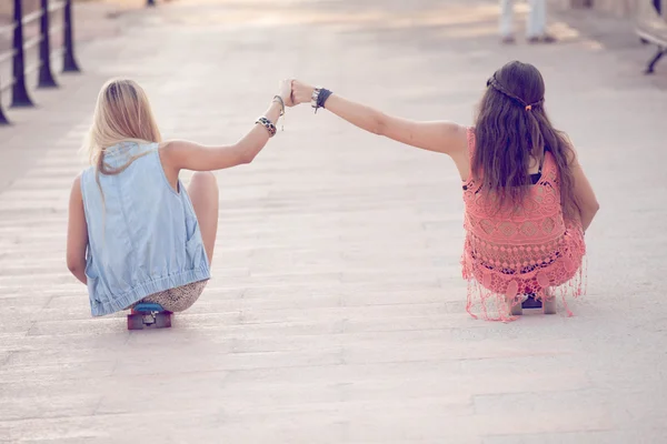 Summer teens girls sitting on skateboards — Stock Photo, Image